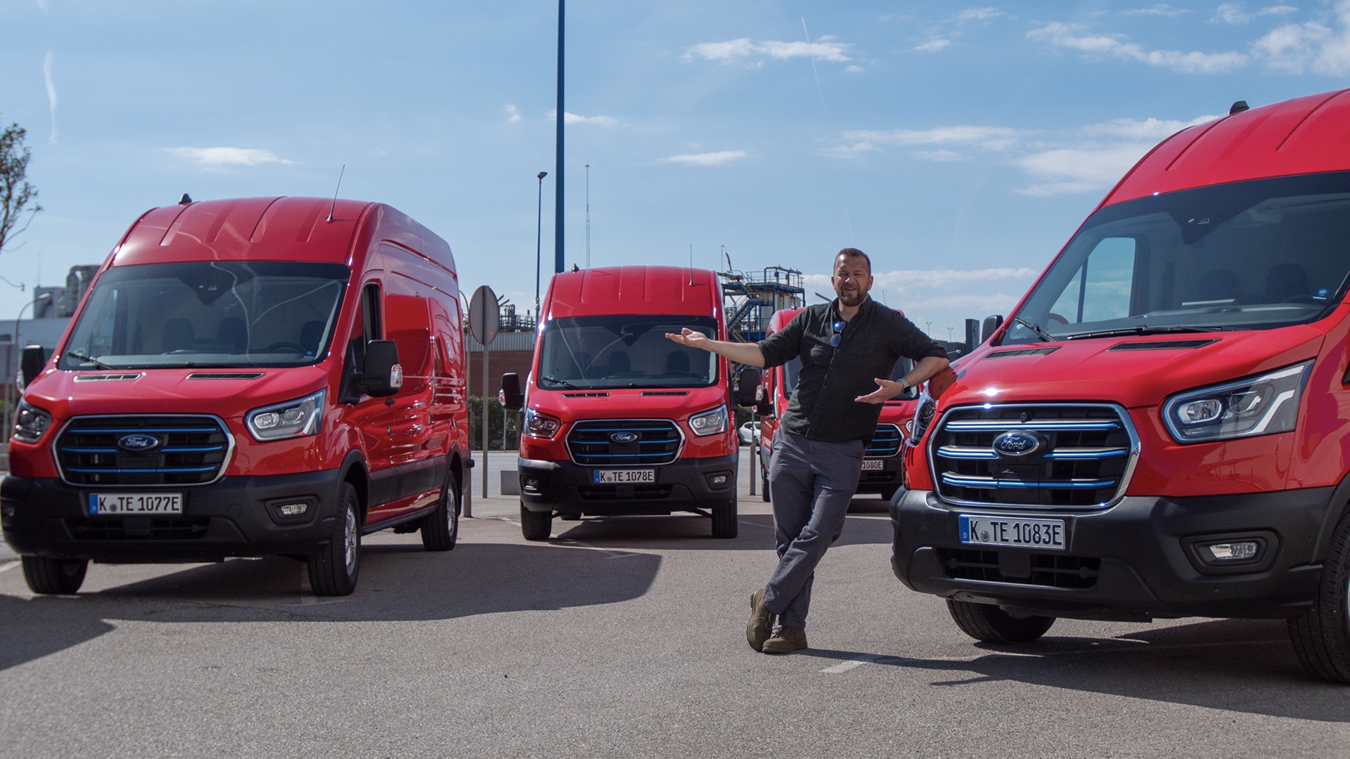 Tom Ford with four Ford eTransits, all red, front views, left hand drive with German registration plates